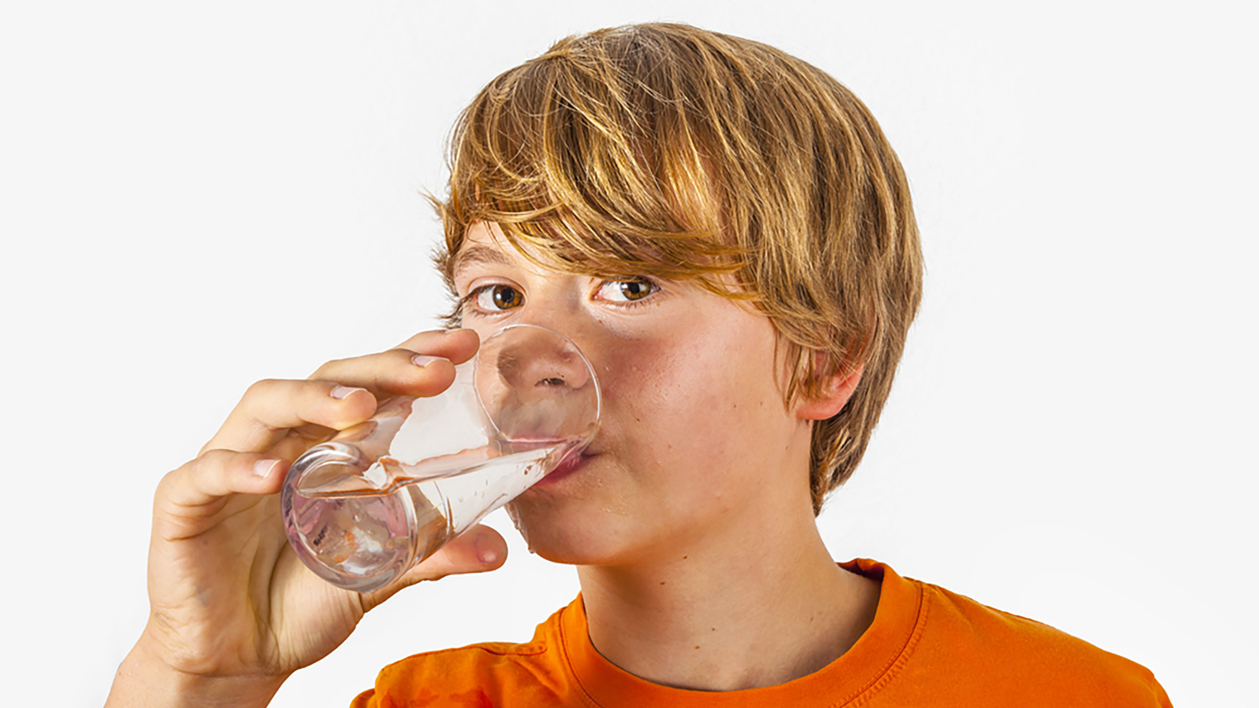 Boy hydrating with glass of water