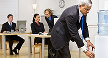 Office people using water cooler